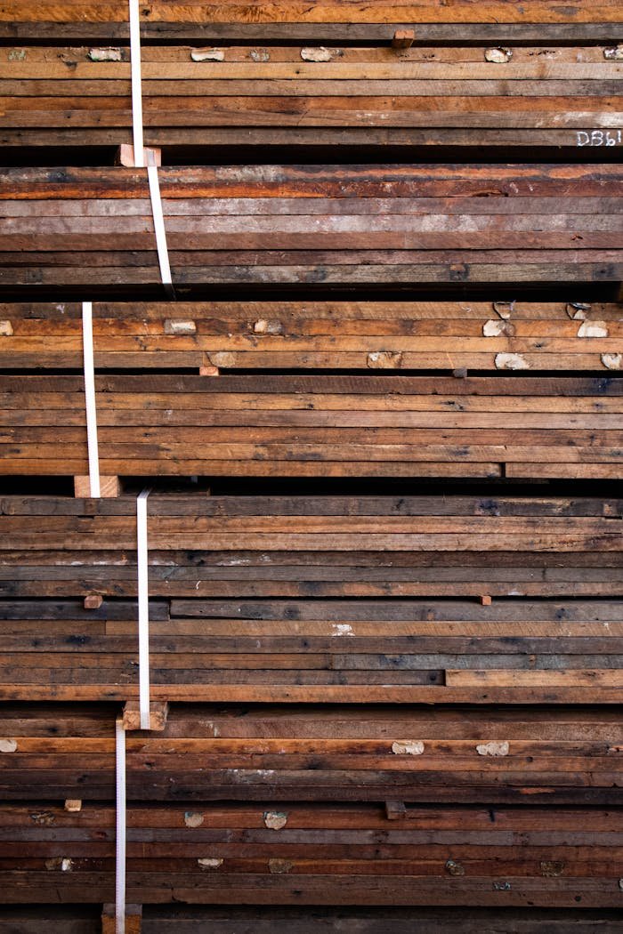 creative-03 Close-up of stacked wooden planks bound for storage or transport, showing texture.