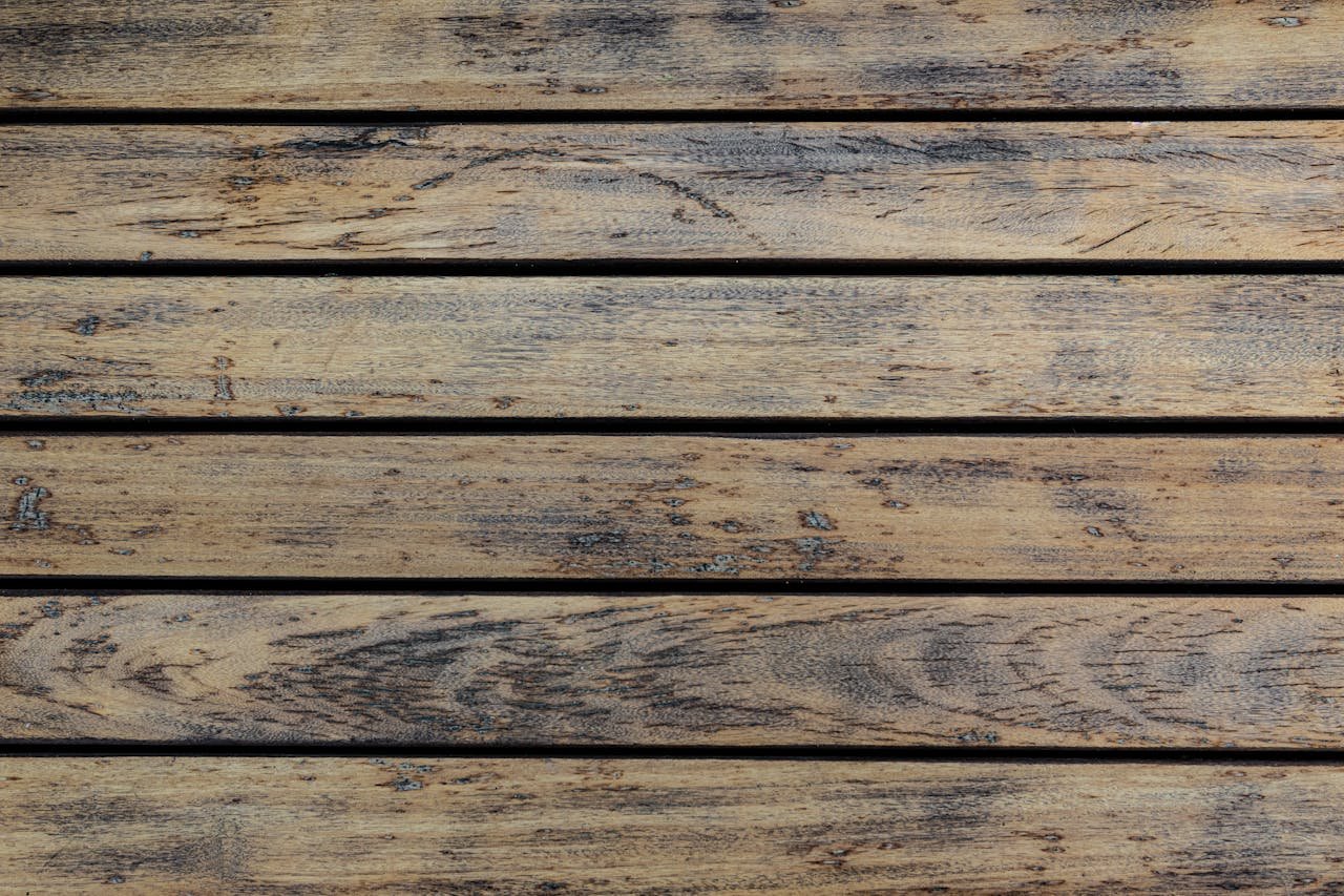 High-resolution image of a rustic wooden floor texture with natural grains and earthy tones.
